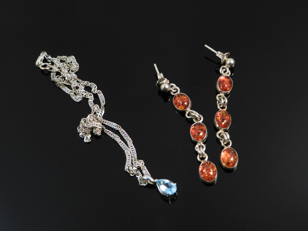 A 9ct white gold chain set with an aquamarine pendant along with a pair of silver and amber