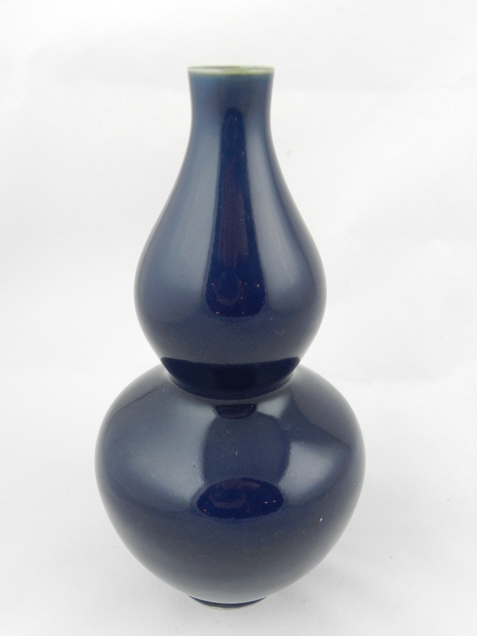 A Chinese blue glazed double gourd vase.