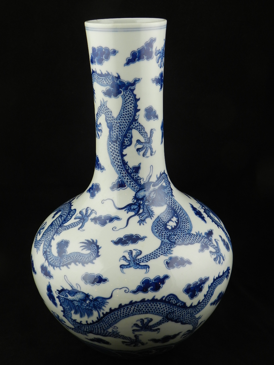 A large Chinese blue and white porcelain bottle  vase decorated with five dragons flying amongst