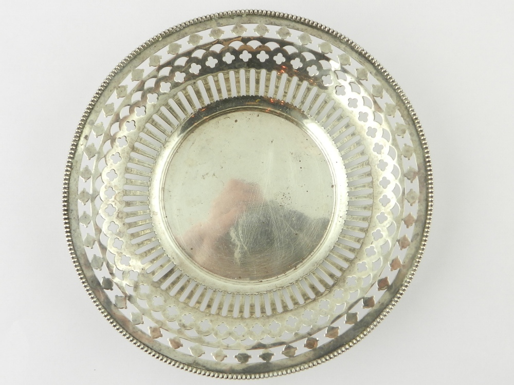 An American sterling circular nut dish with bar and scroll pierced sides