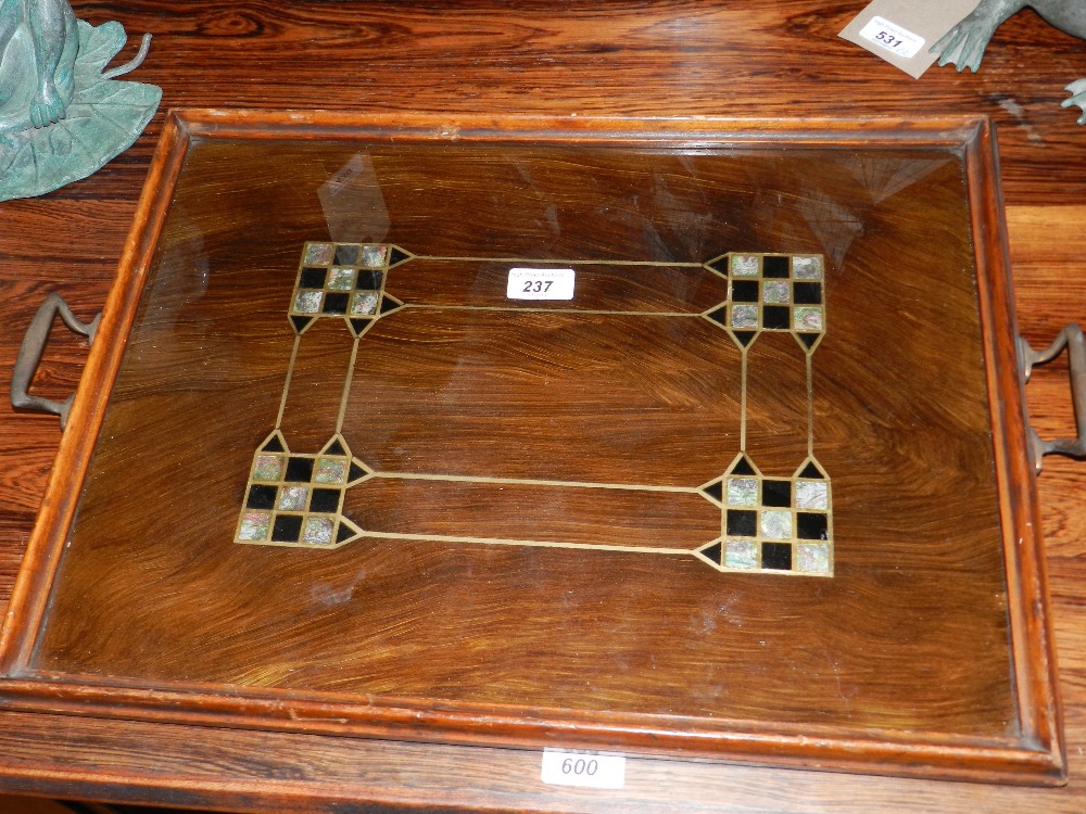 A Secessionist wooden twin handled tray with a central linear design and with angular ends