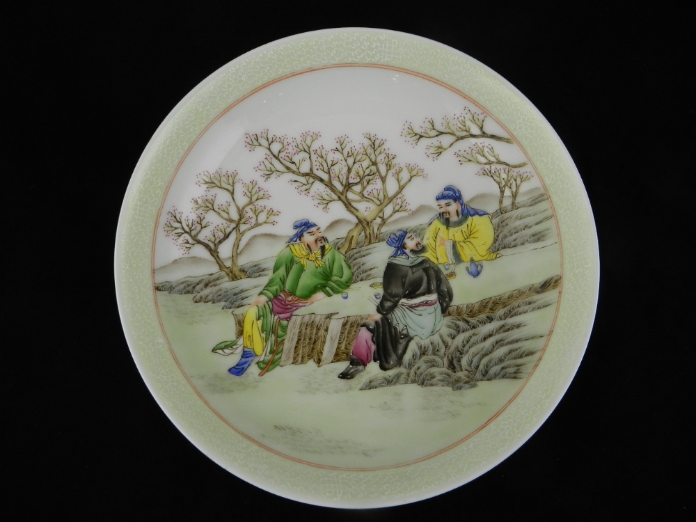 A Chinese porcelain dish decorated with three men taking food. Bears character mark to the base,