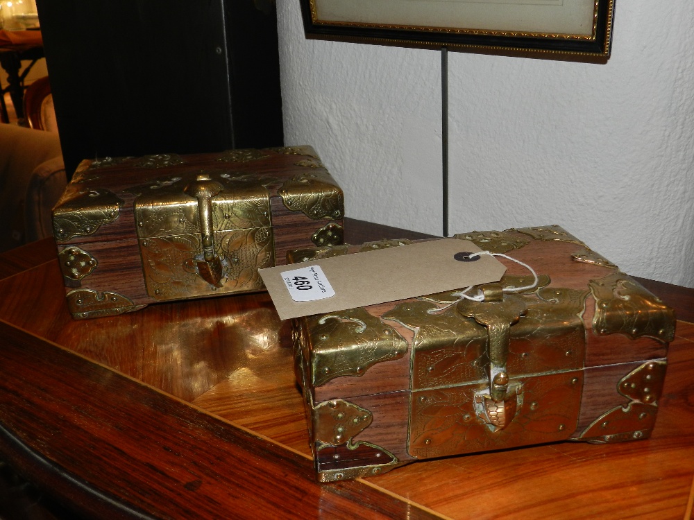 A pair of oriental hardwood caskets having brass clasps and mounts