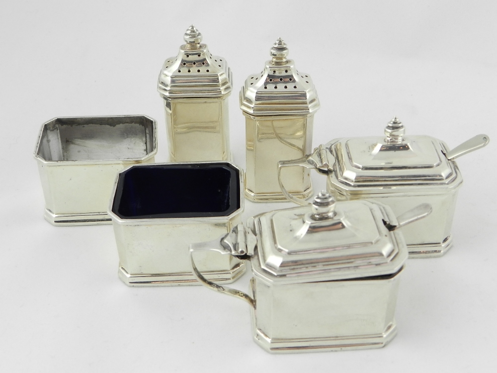 A six piece silver condiment set of octagonal form with two condiment spoons