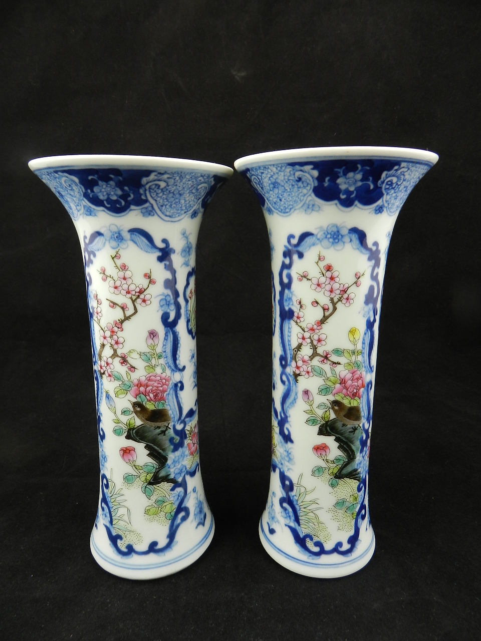 A pair of late 19th century/early 20th century Chinese slim stem spill vases both decorated with