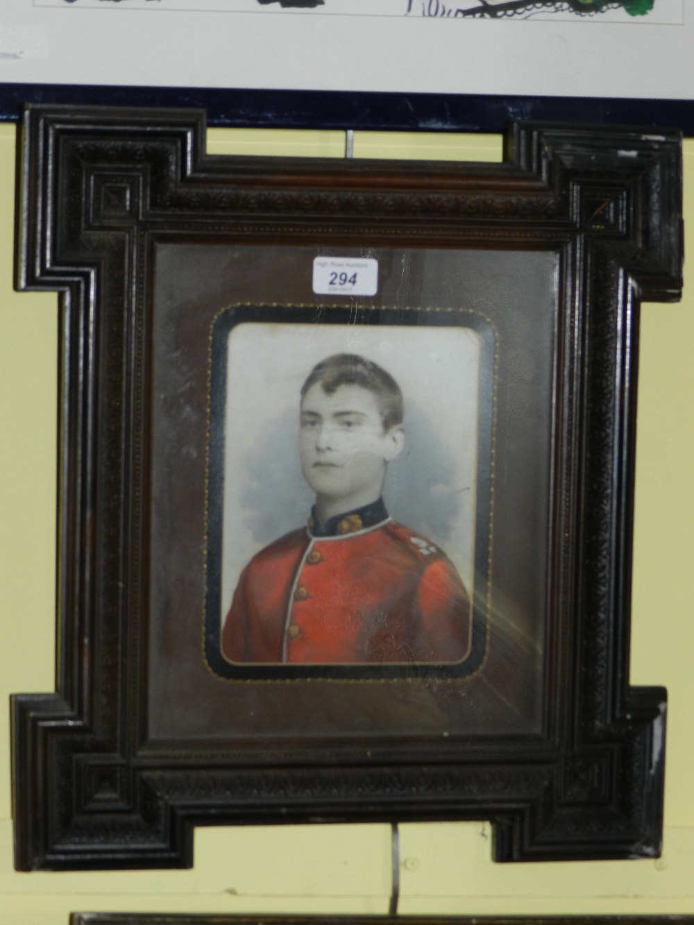 A portrait of a young First World War soldier wearing red and blue tunic of the Royal Fusileers in a