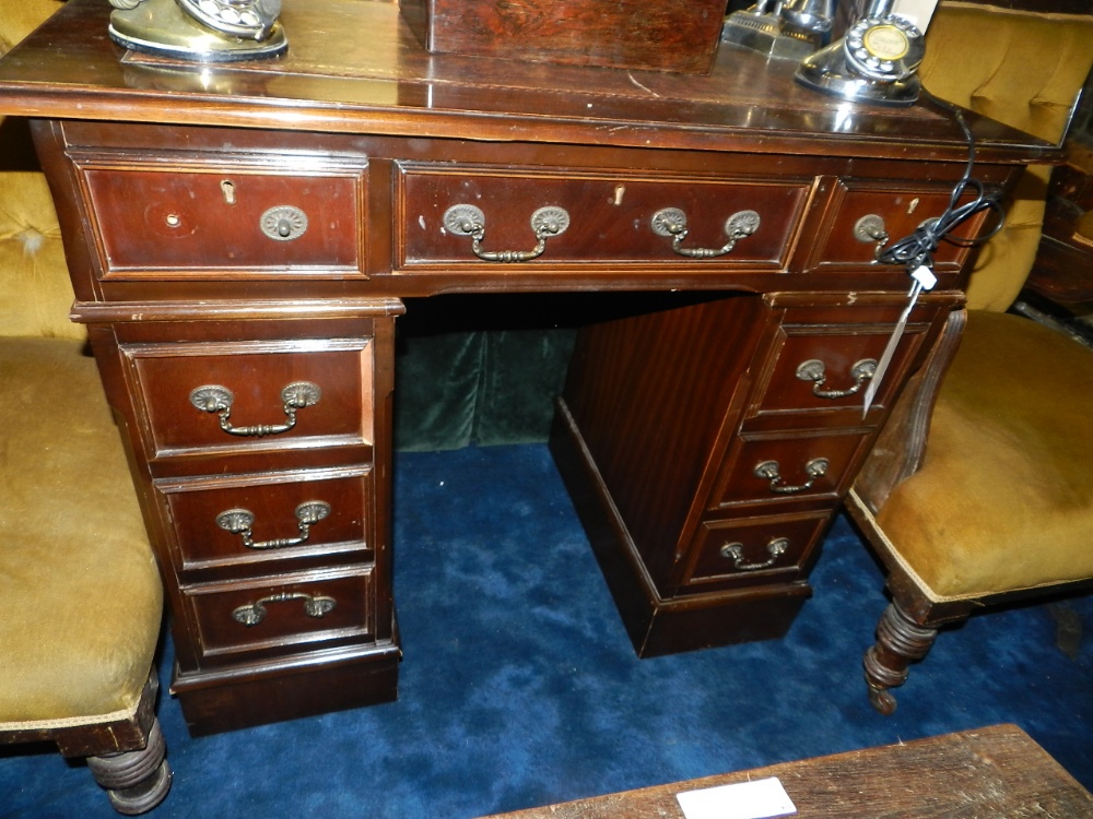 A mahogany pedestal desk with gilt tooled leather insert above on arrangement of eight drawers
