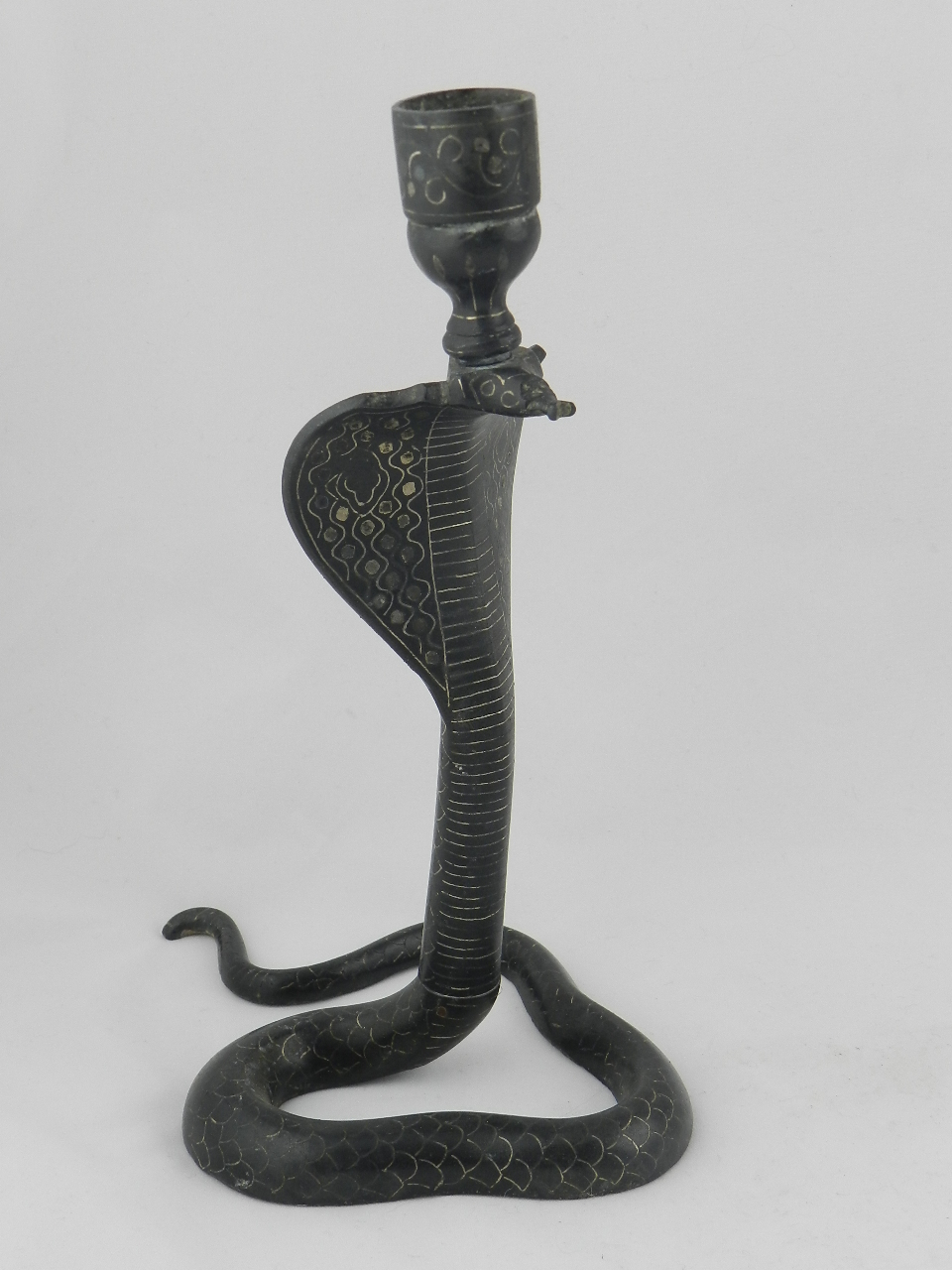 A bidri work snake shape candle stick.