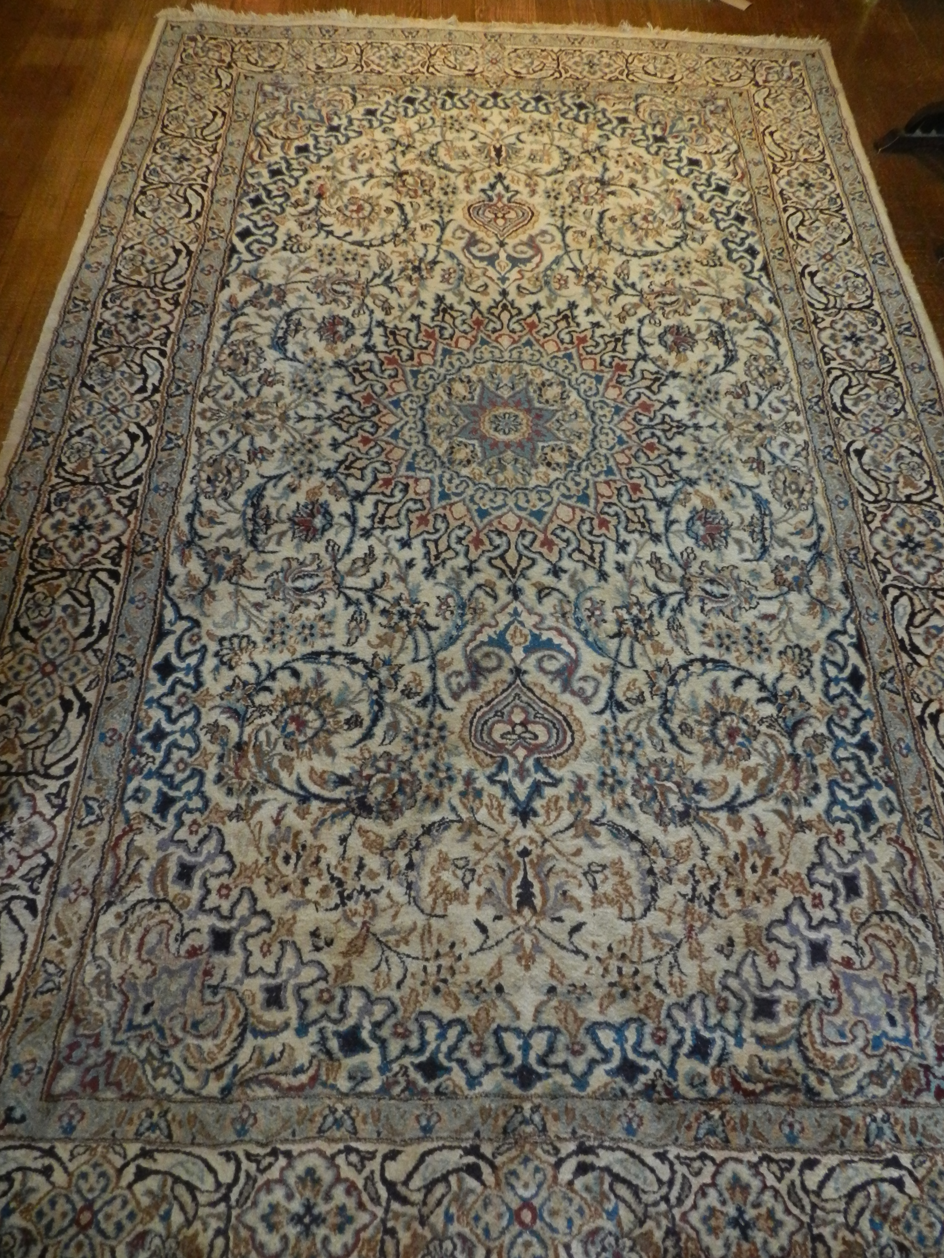 A large Persian rug 2m x 2-80m. Silky woollen mix having floral geometric designs, pale blue in an