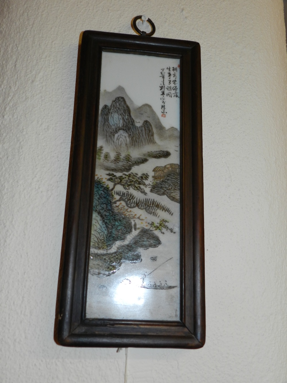 A Chinese painted porcelain panel depicting fishermen with a dramatic outdoor scene backdrop.