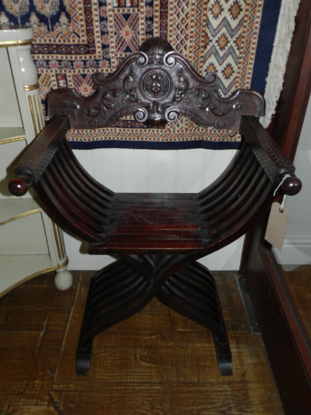 A pair of carved oak folding x framed window chairs,  one a/f