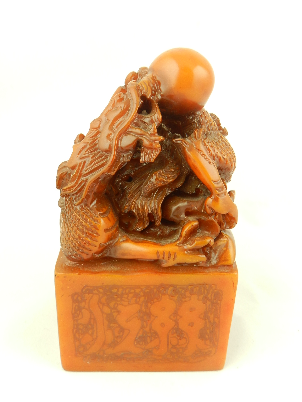A large carved soapstone seal having dragon and pearl finial.