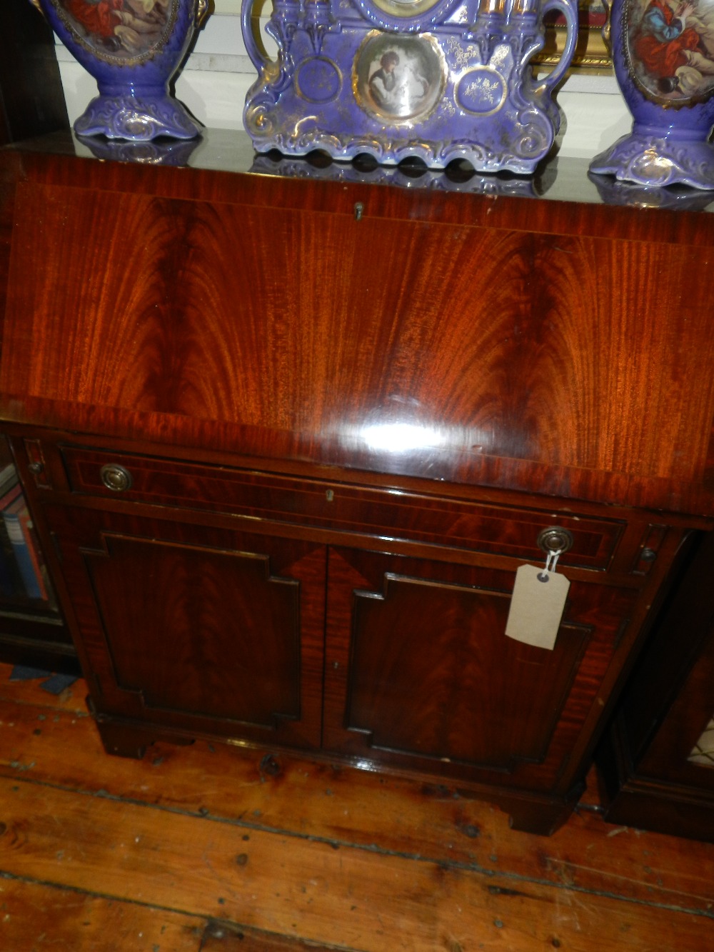 A Regency style mahogany fall front bureau above drawers along with related chair.