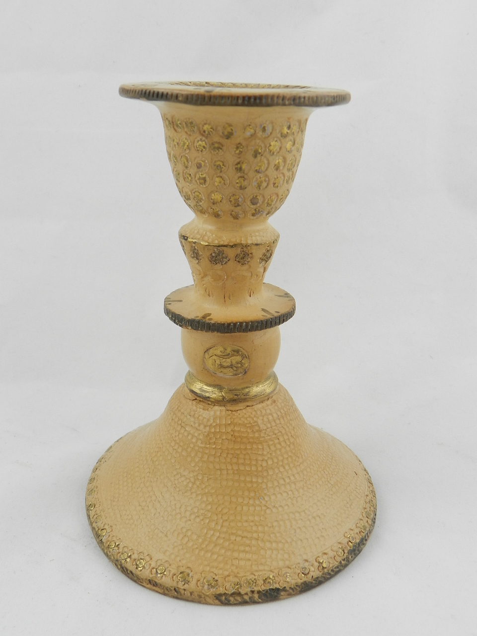 A Turkish, pale terracotta candlestick with Tugra and signature on raised circular base.