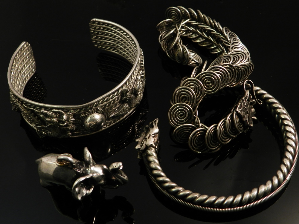 Chinese white metal jewellery to include three bracelets and an elephant pendant