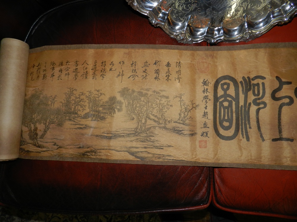 An oriental horizontal scroll picture of an extensive landscape scene decorated with character marks