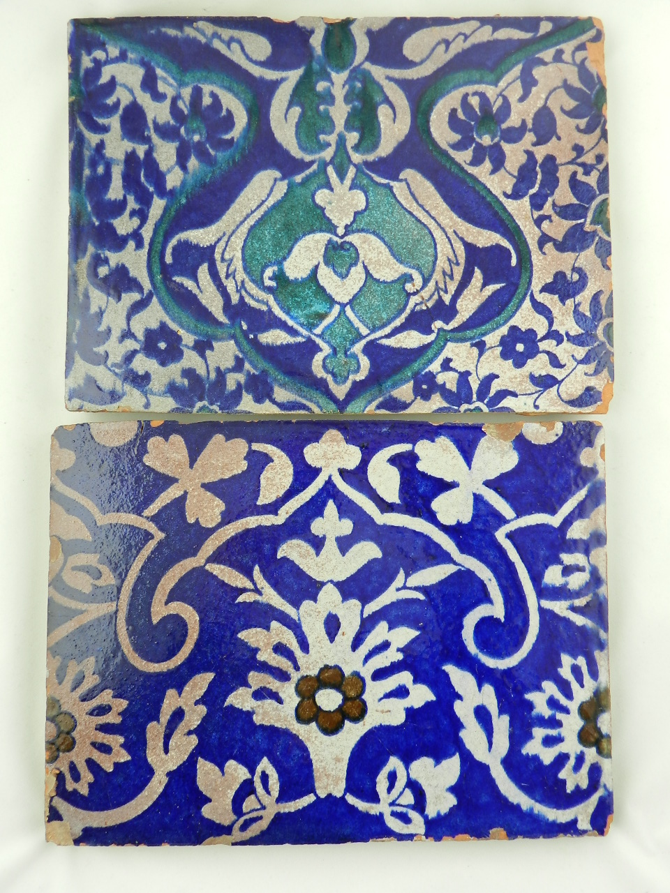 Two Islamic 18th century Multan tiles decorated with stylized flowers and leaves in turquoise and