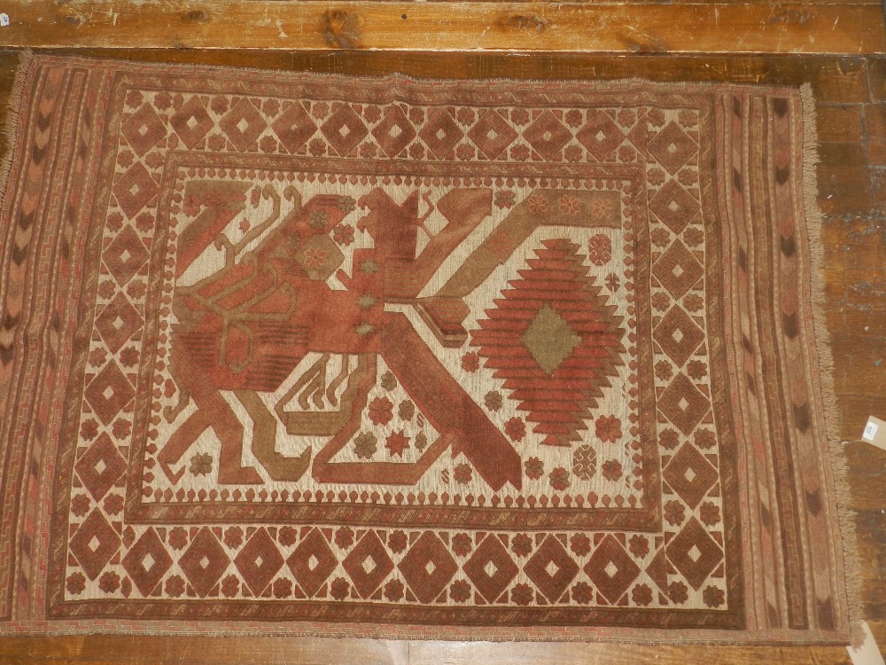 A kelim rug having stylized designs in browns and reds