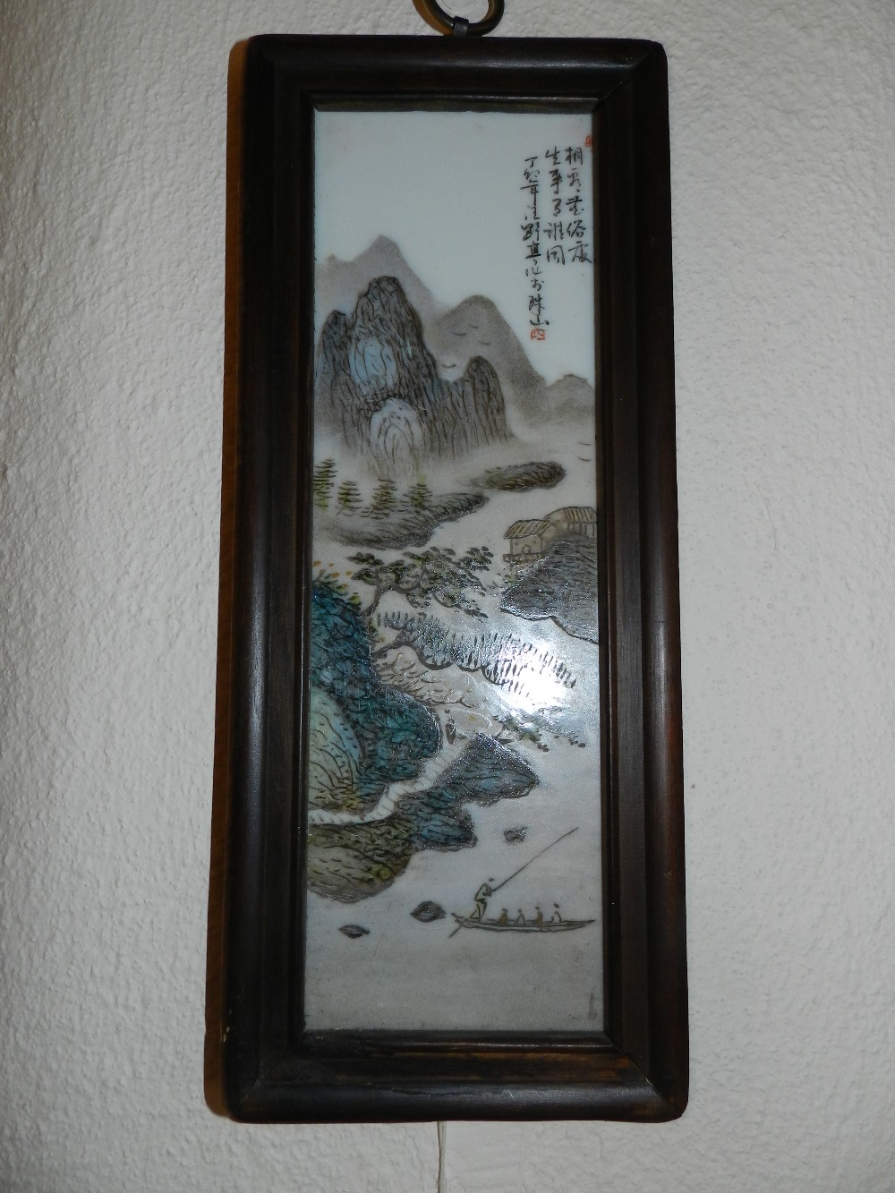 A Chinese painted porcelain panel depicting fishermen with a dramatic outdoor scene backdrop.