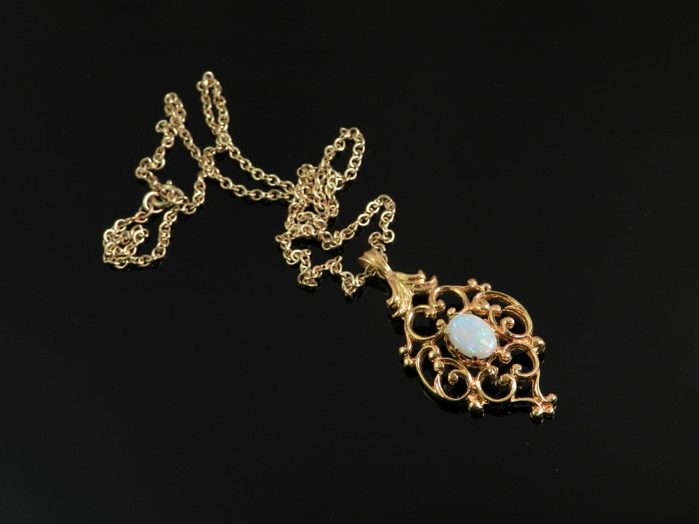 A 9ct yellow gold chain with pendant set with an oval opal.