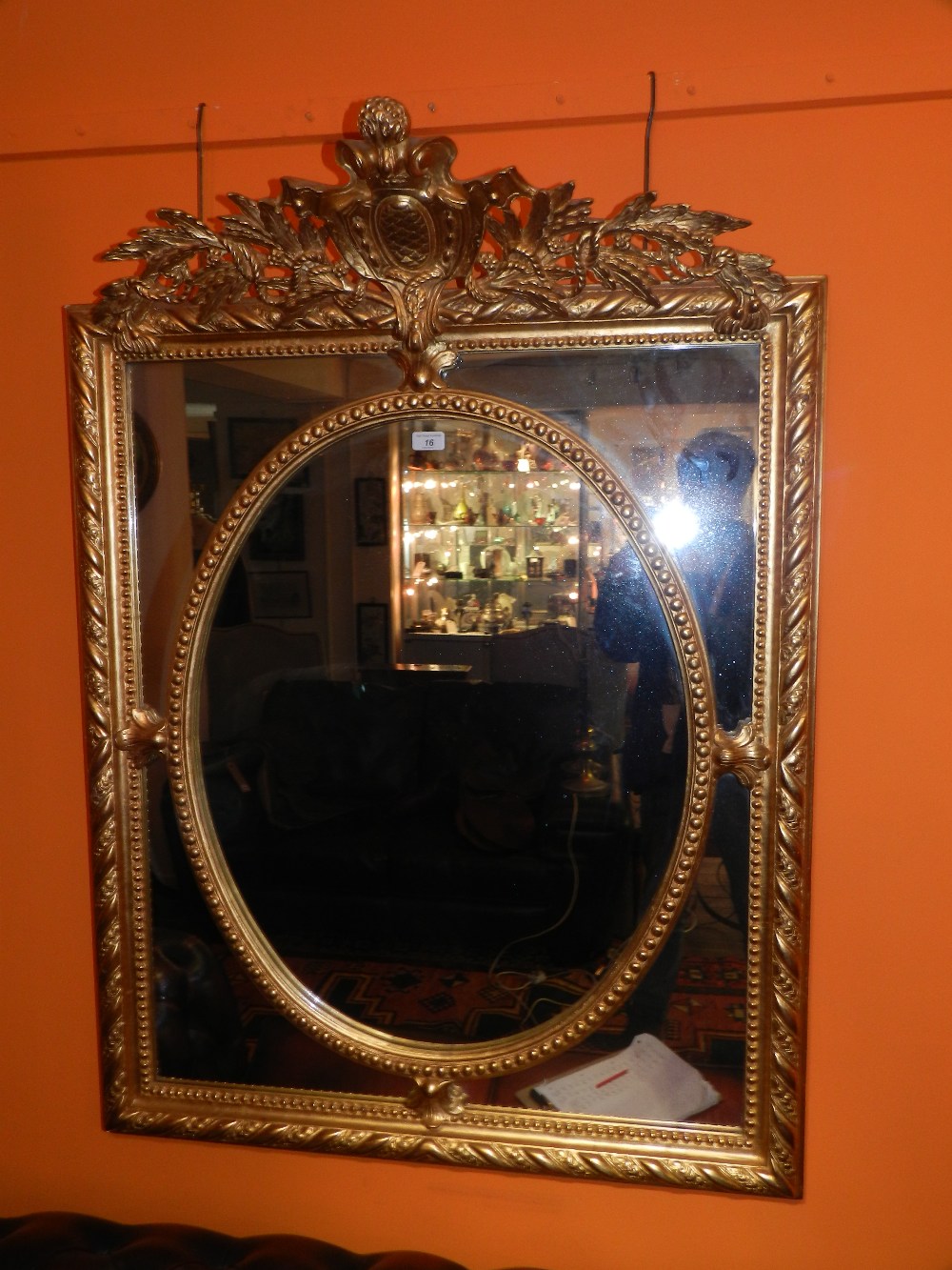 A large gilt wood framed sectioned mirror having and over hanging crest.