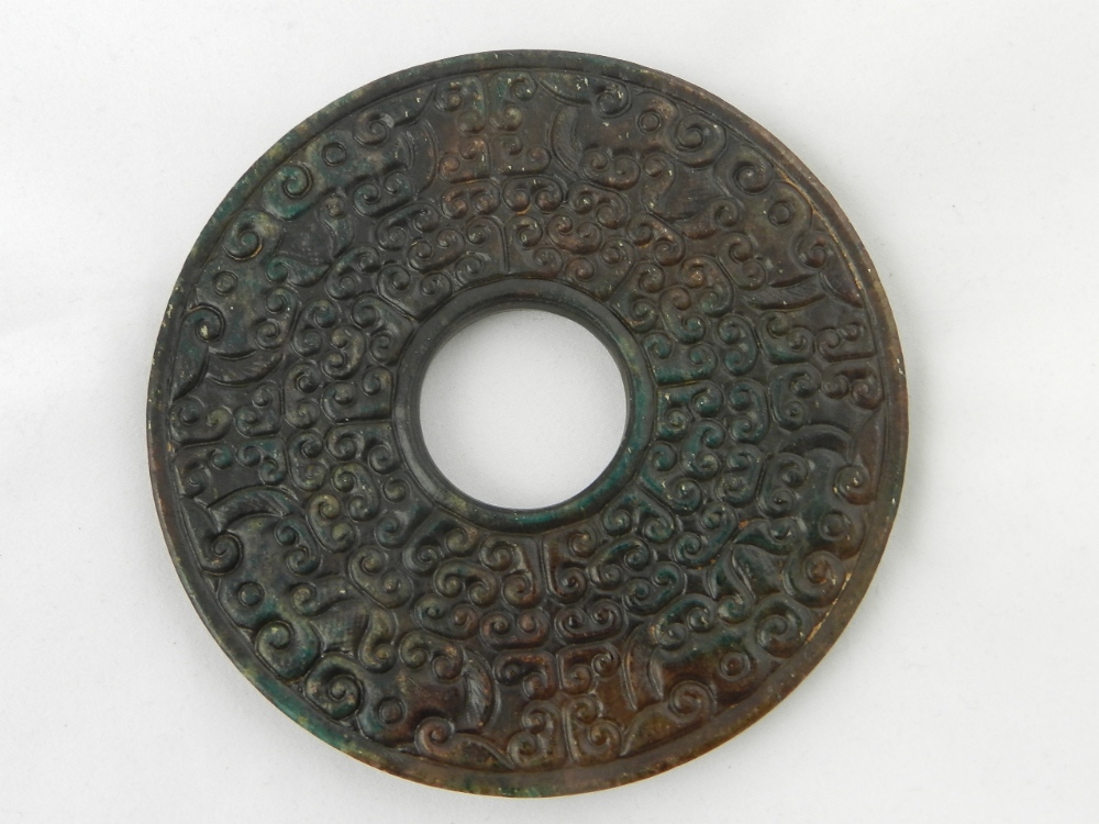 A Chinese carved jade disk pendant.