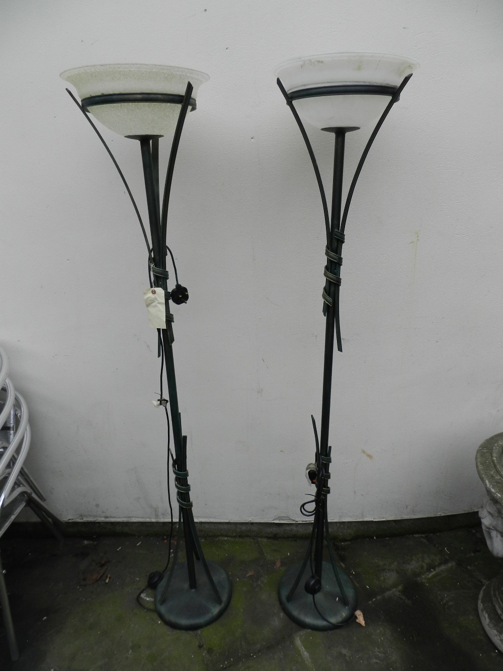 A pair of painted metal ware lamp standards having opaque glass shades.