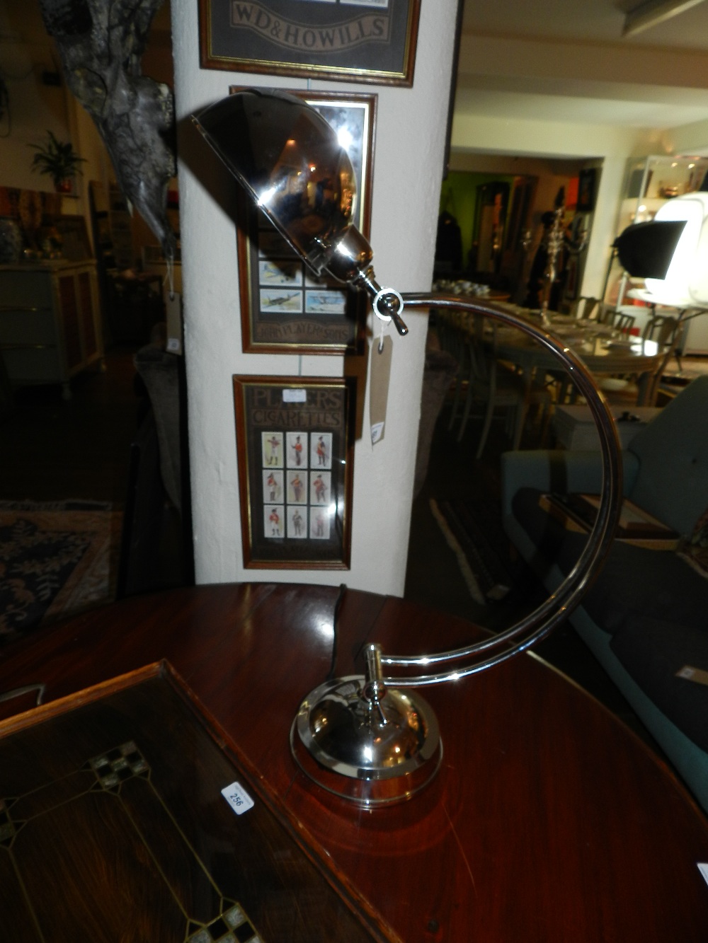 An Art Deco style nickel plated adjustable lamp of Arc form having domed shade