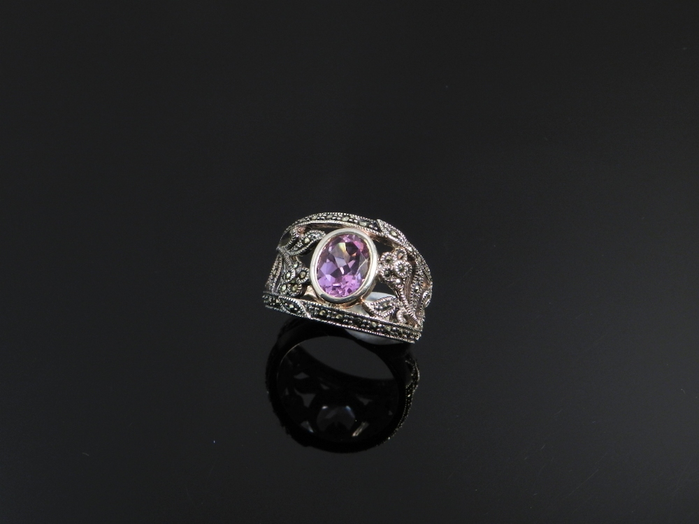 A sterling silver ring set with oval amethyst and marquisette.