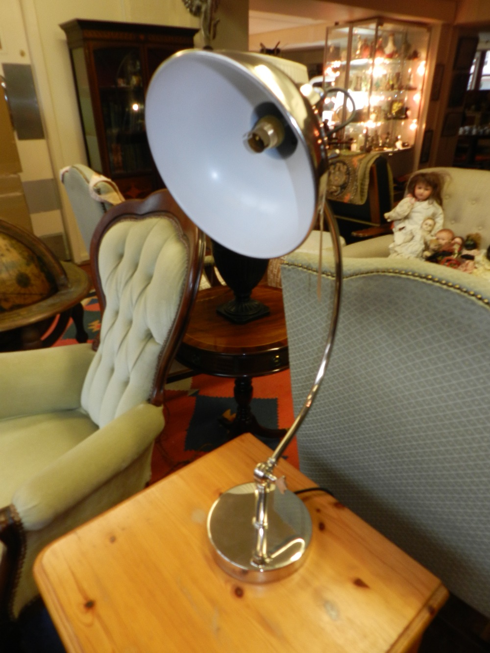 An Art Deco style silver plated adjustable lamp base of overhanging arc form.