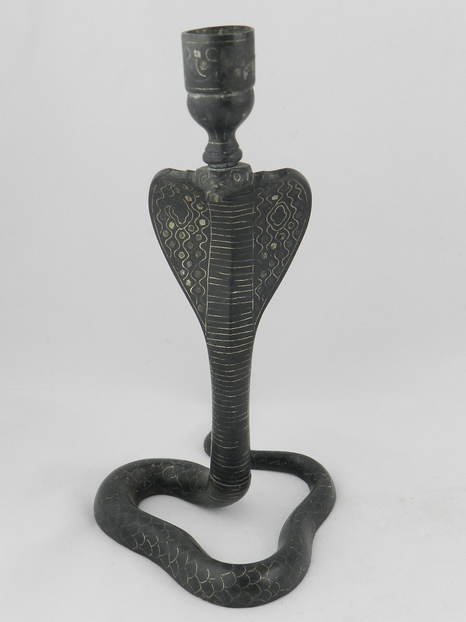 A bidri work snake shape candle stick.