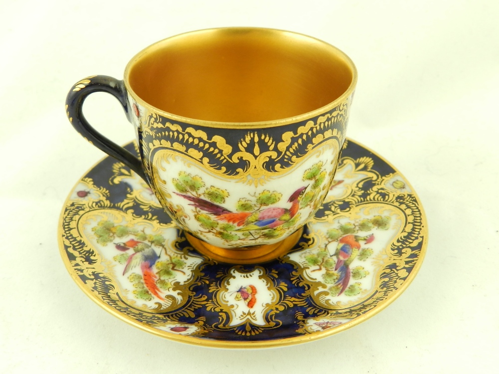 An early 20th Century Royal Worcester porcelain cabinet cup & saucer, decorated with hand painted