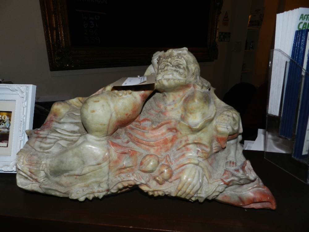 A large carved marble statue of a learned man emerging from within a lotus leaf. (blush pink marble)