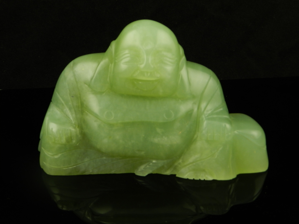 A carved jade seated Buddah.