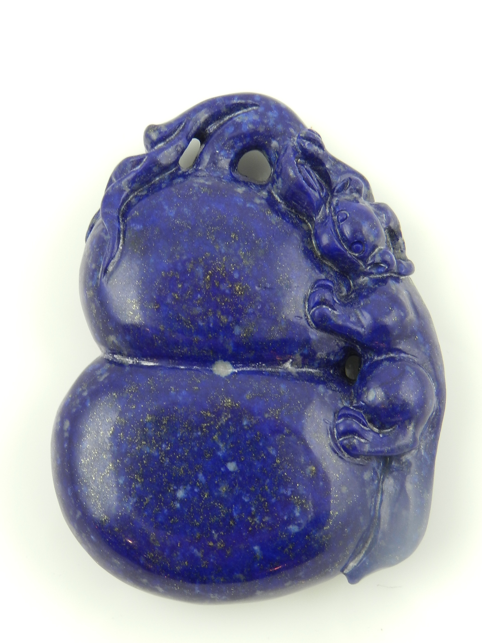 A Chinese lapis lazuli paperweight carved with a Chinese dragon.