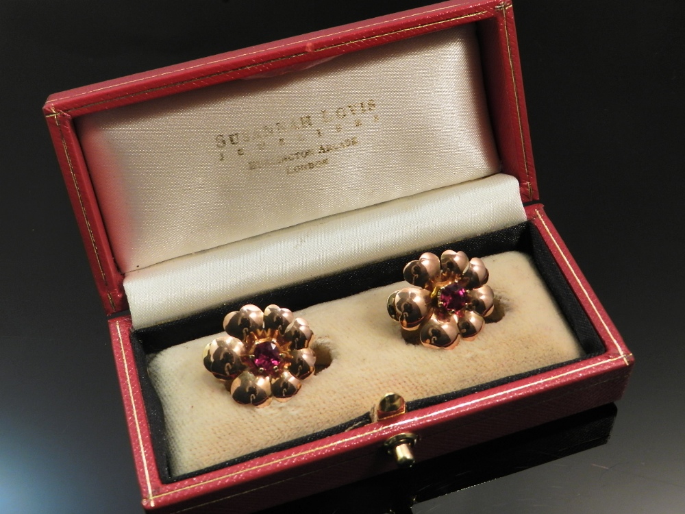 A cased pair of 14ct gold floral earrings set with pigeon`s blood rubies.