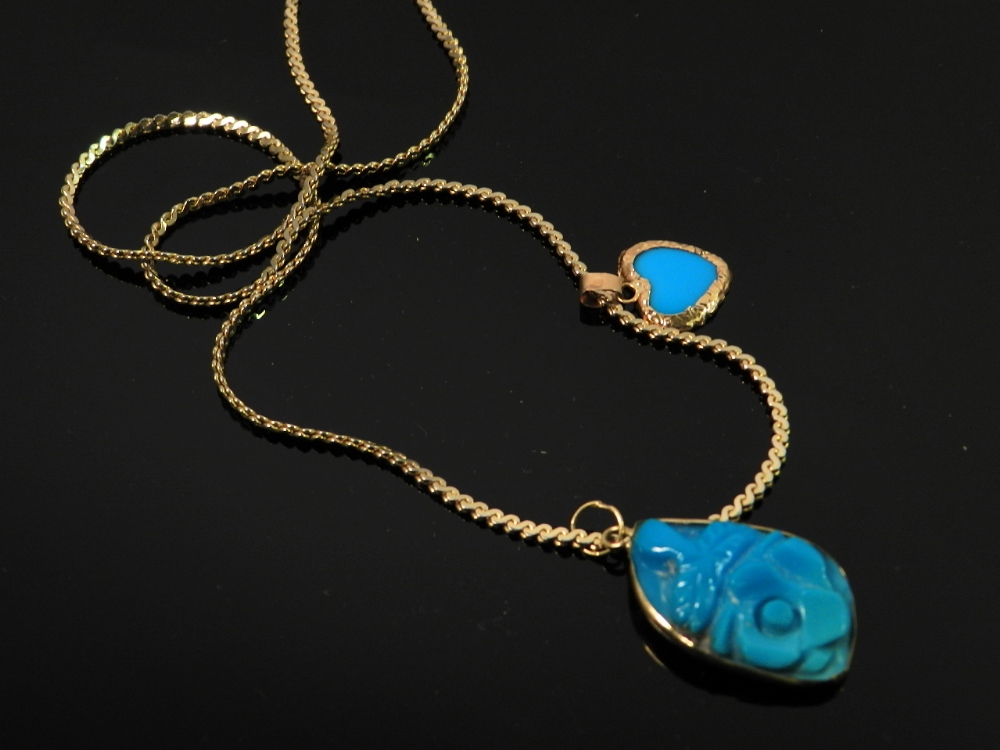 A carved turquoise pendent along with a smaller heart shaped pendent both in 18ct yellow on a plated
