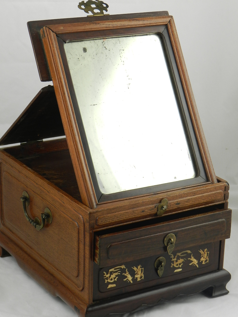 A Chinese hardwood travelling vanity case with hinged top above two drawers inlaid with bone figures