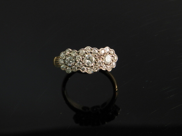 An 18ct gold diamond mounted triple cluster ring.