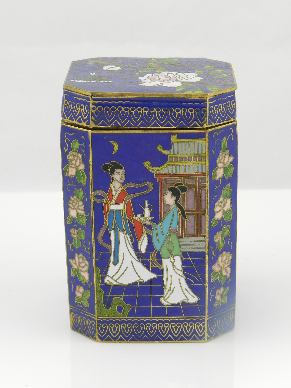 An oriental cloisonne tea caddy of rectangular form having canted corners decorated with various