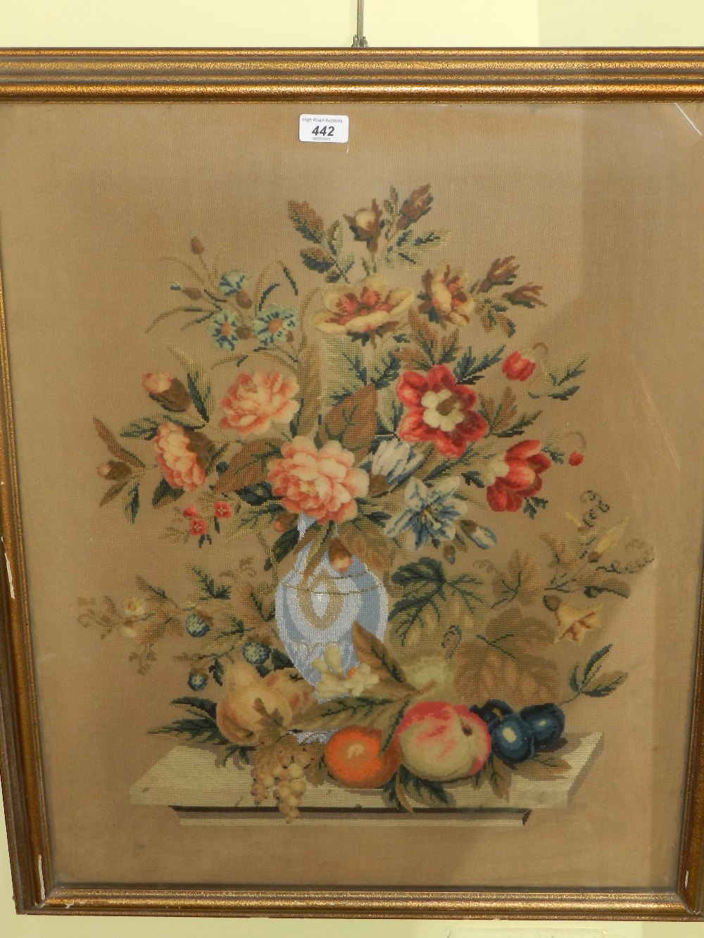 A 19th Century glazed and framed needle point and Berlin work of a still life of a vase of flowers.