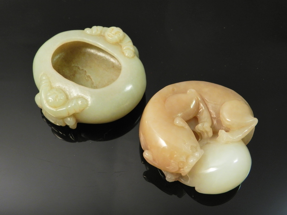 A Chinese jade ink well decorated with animals together with a carved jade paperweight in the form