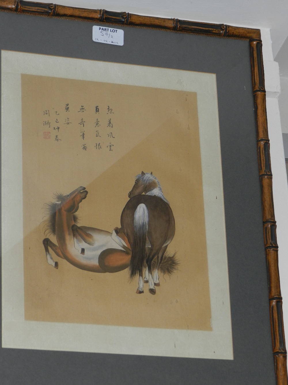 A pair of Chinese paintings of horses on silk paper, both signed and framed in bamboo.