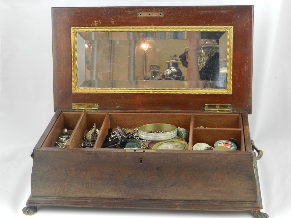 A large collection of costume jewellery filled in a 19th century chest.