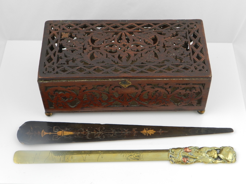 A Regency treen page turner decorated with yellow vases,green foliage and a male mask,an antique