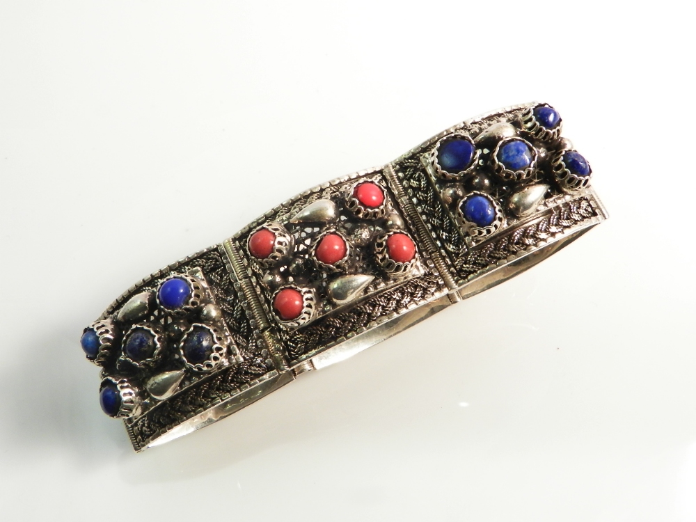 A 925 silver bracelet set with cabochon coloured stones.