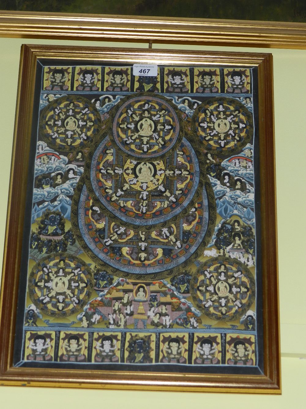 A gilt framed Tibetan silk tanka.