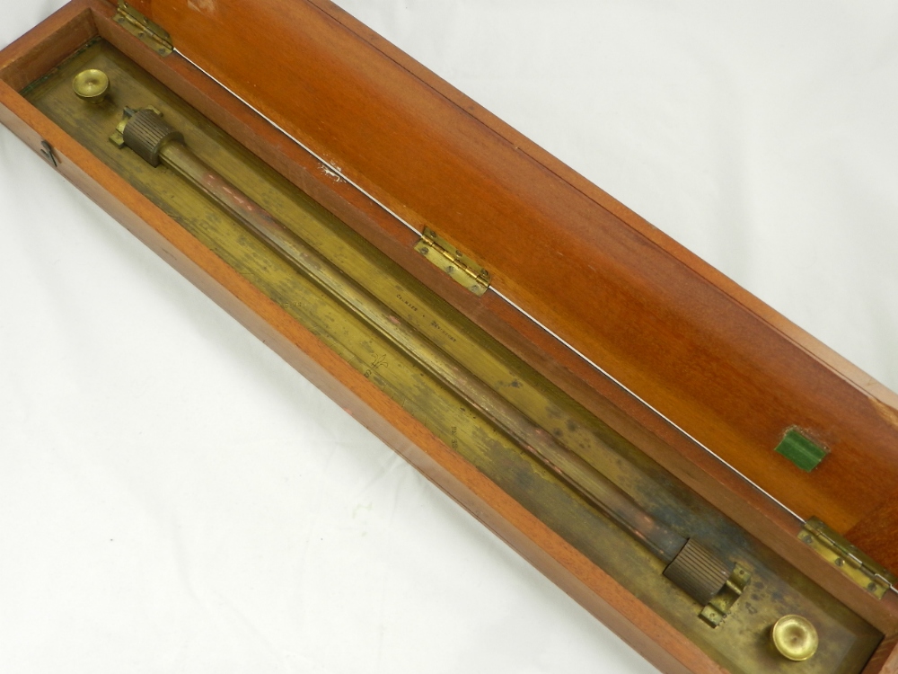 A naval brass rolling ruler signed Coombes in a fitted mahogany case.