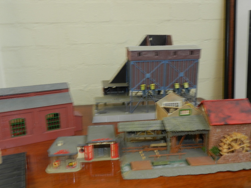 A quantity of toys to include Triang and Vollmer railways, buildings and cars.