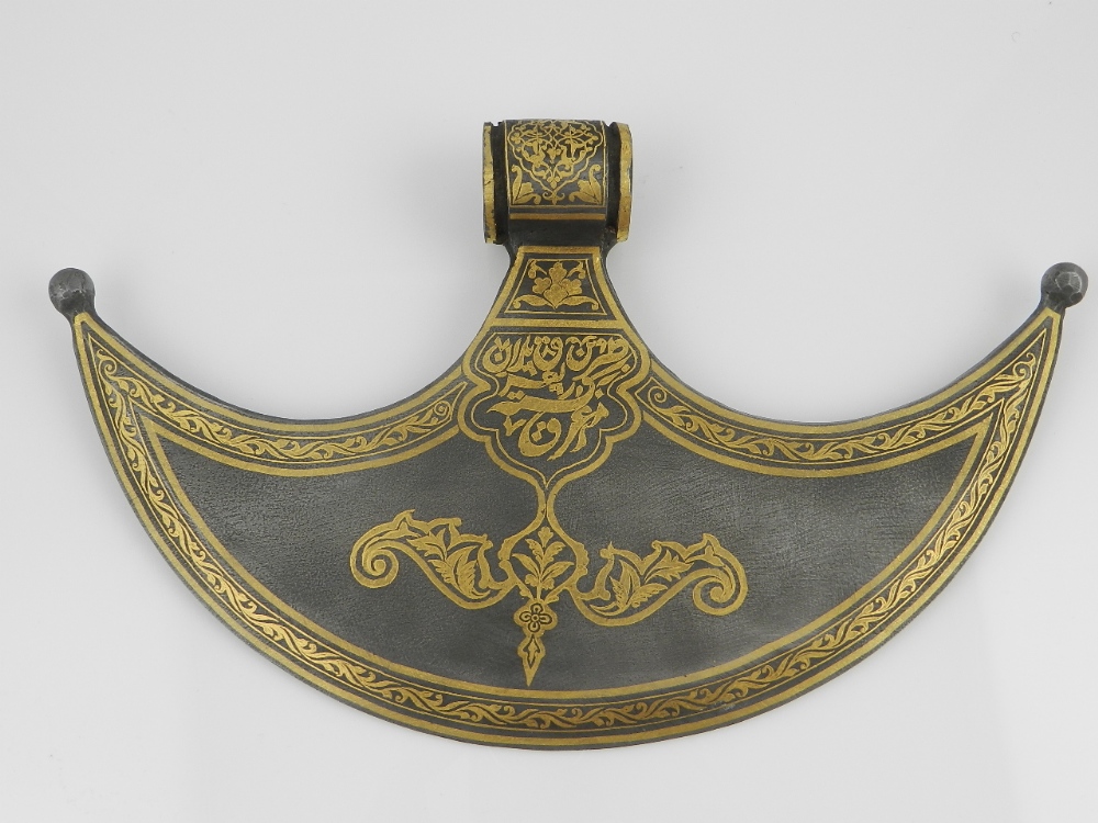 A Turkish ceremonial damascene axe head decorated with stylized leaf border